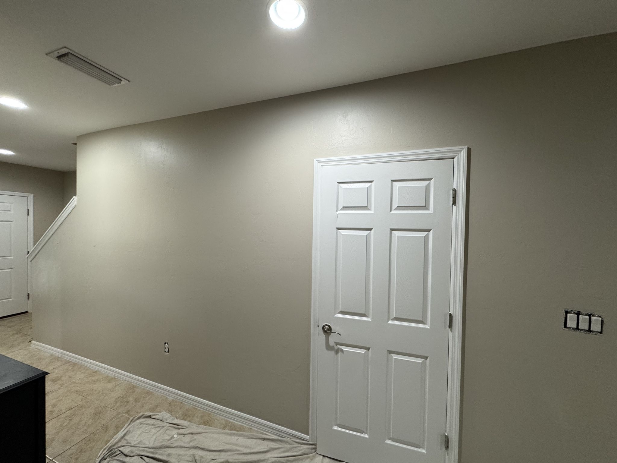 Drywall repair and fresh paint in a hallway by Too C's Painting